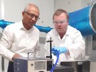 Kromek CEO Dr Arnab Basu (L) tests the volume sampling pump inside the bioaerosol chamber